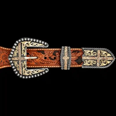 A custom western three piece belt buckle set featuring copper crosses and golden bronze scrollwork 
